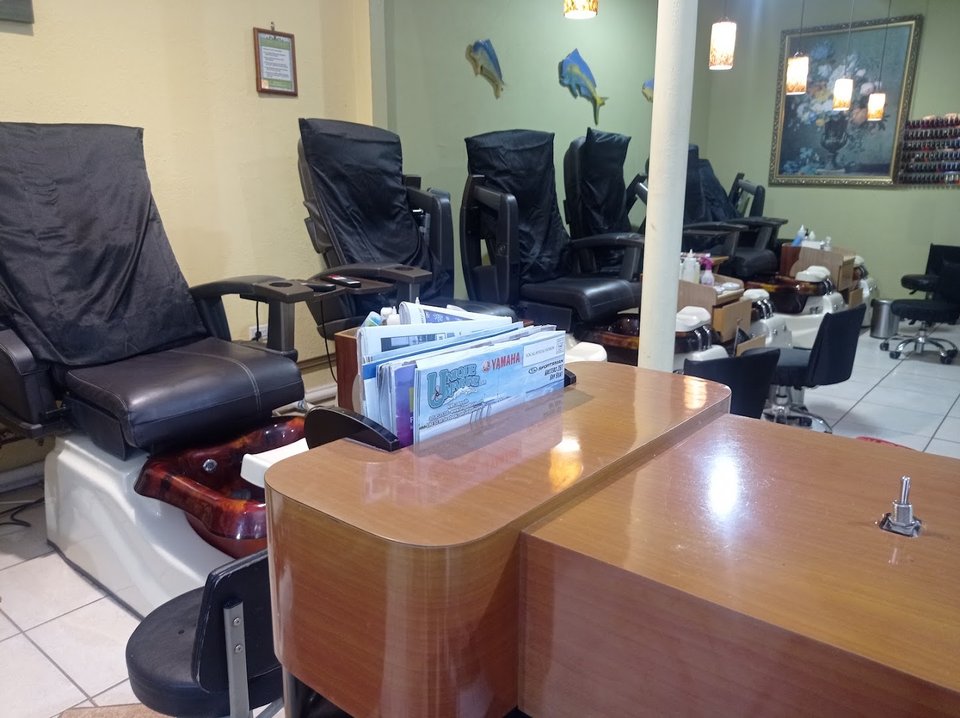 Clean nail salon interior with manicure stations.